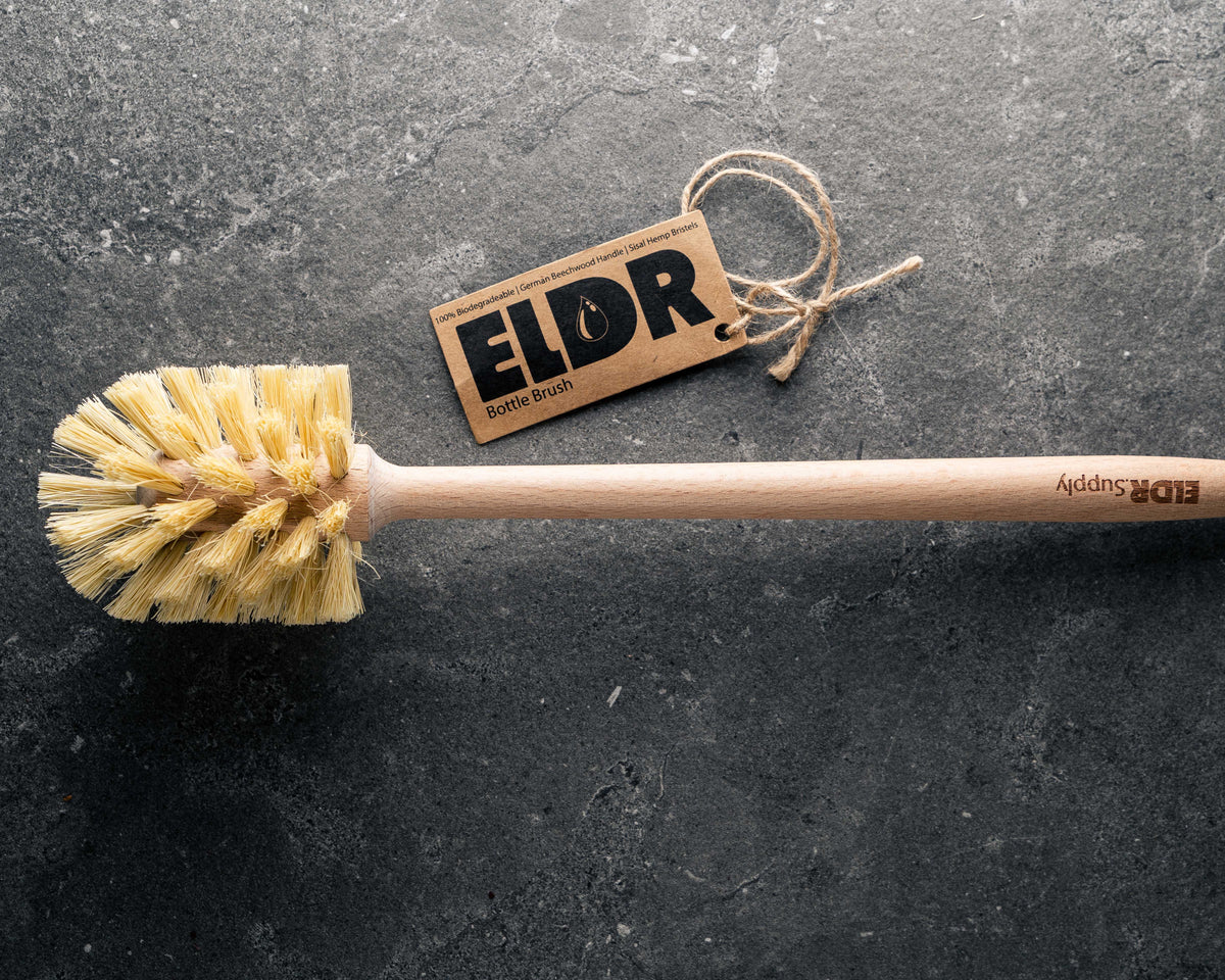 ELDR wooden bottle brush on a dark stone surface