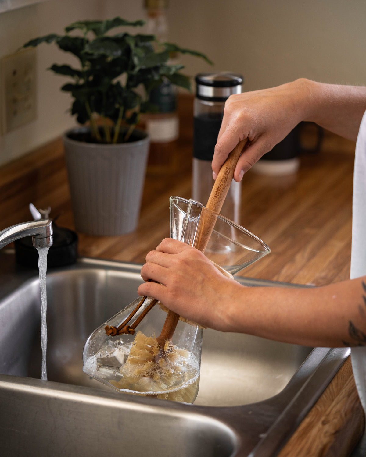 ELDR wooden bottle brush cleaning a glass pitcher